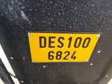 a yellow sign on the side of a black car
