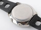 a close up of a watch on a white surface