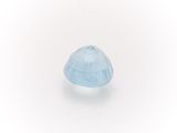 a close up of a blue topazte stone on a white surface