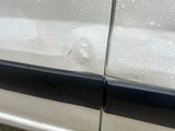 a close up of a car door handle with water on it