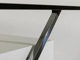 a close up of a glass table with a metal frame