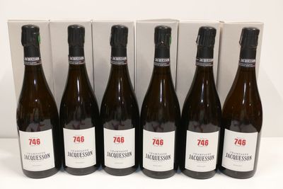 six bottles of wine are lined up in a row in front of a box