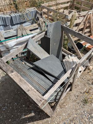 a pile of concrete blocks sitting on the ground next to a fence