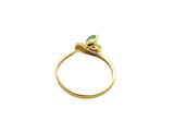 a close up of a gold ring with a green stone