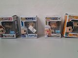four pop vinyl figures are lined up in a row on a table