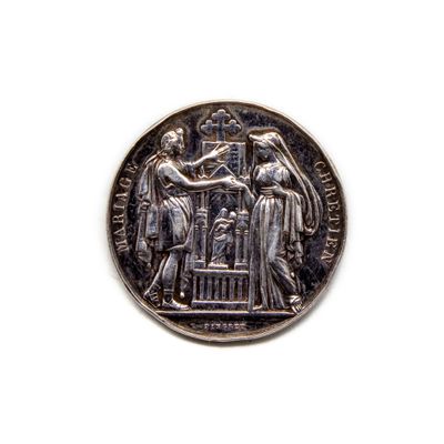 une image représentant une pièce d'argent sur laquelle figurent une femme et un homme