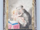 an old picture of a man holding a baby in his lap
