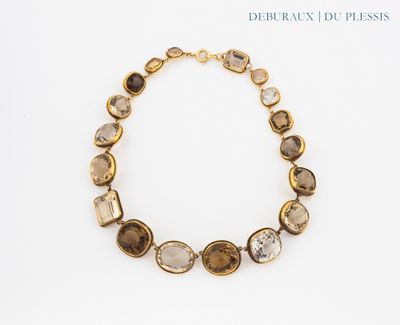 a close up of a necklace on a white surface