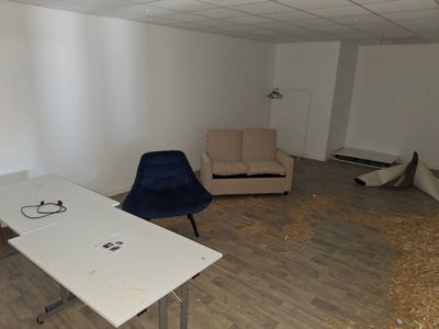 two chairs and a table in a room with wood flooring