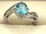 une image d'une bague avec une pierre en topaze bleue