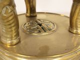 a gold statue of a man with a sword on top of a table