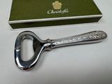 a bottle opener that is sitting next to a box
