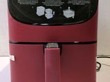a red air fryer sitting on a counter
