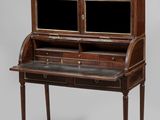 un bureau ancien à deux tiroirs et doté d'un plateau en verre