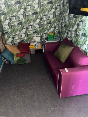 a room with two couches and a table in it