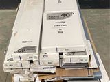 several boxes of electronic equipment are stacked on pallets in a warehouse