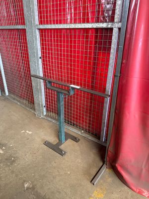 a red wall behind a metal fence with a red tarp