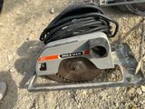 someone is using a circular saw to cut a hole in the ground