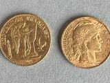 two gold coins, one of which is a woman and one of which is a man