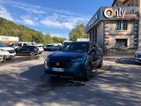 a blue car parked in front of a building in a parking lot