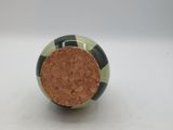 a green and white ball with a cork in it