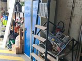 an image of a garage with a lot of tools on the floor