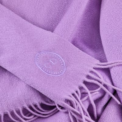 purple scarf with a logo on it laying on top of a table