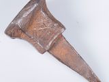 an old metal object on a white surface with a white background