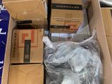 many boxes of assorted items sitting in a pile