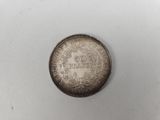 an old silver coin with the inscription ' 50 cents ' on it