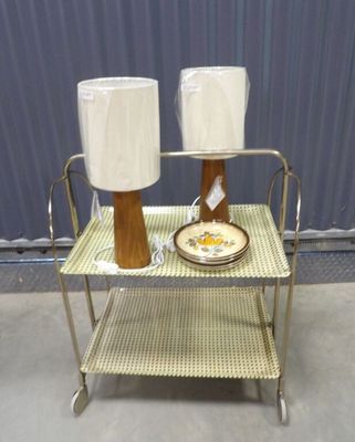 a table with two lamps and a plate on it