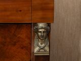 a statue of a man sitting on top of a dresser