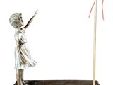 a statue of a girl with a balloon on a stand