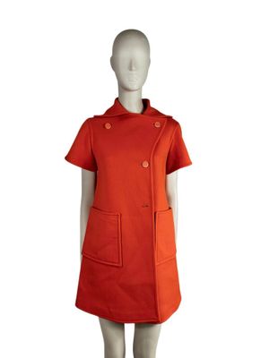 an image of a mannequin wearing an orange dress with buttons