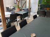 a table and chairs on a patio with a red awning