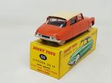 a red toy car sitting on top of a yellow box