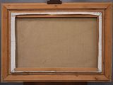 an old picture frame with a piece of cardboard on top of it
