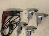 three air tools are sitting on a table next to a cord