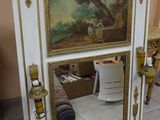 a picture of a mirror with a painting on it