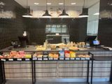 an image of a bakery counter with lots of food on it