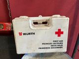 a first aid box sitting on top of a metal barrel