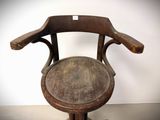 a wooden chair that has a wooden seat on it