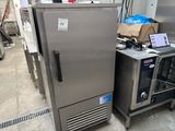 a refrigerator and a freezer sitting next to each other in a warehouse