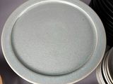 many plates and bowls that are sitting next to each other