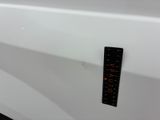 a sticker on the door handle of a white car