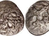 a close up of two silver coins on a white surface