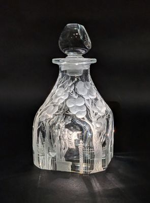 a clear glass bottle with a glass stopper on it