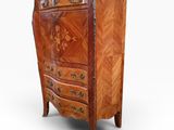 an antique wooden chest of drawers with a marble top