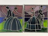 three stained glass panels depicting a woman in a dress and a man in a top hat
