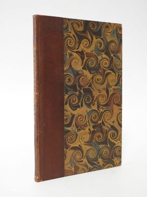 an old book sitting on top of a white table next to a white wall